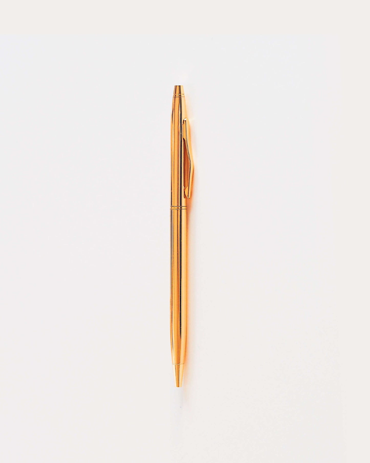 Slim gold ballpoint pen with black ink and medium tip | ella iconic® stationery | UK