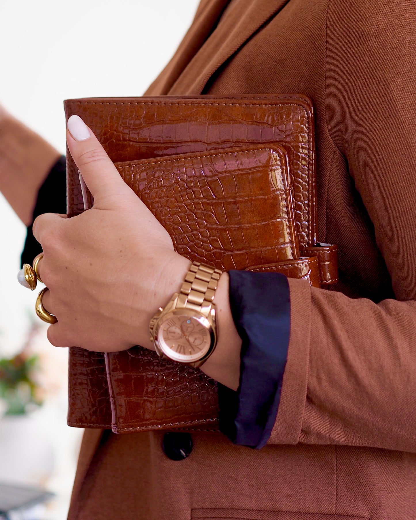 Close-up of cognac croc vegan leather ring binder showing tab closure and embossed texture. By ella iconic® UK.